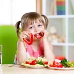 young-girl-eating-vegetables